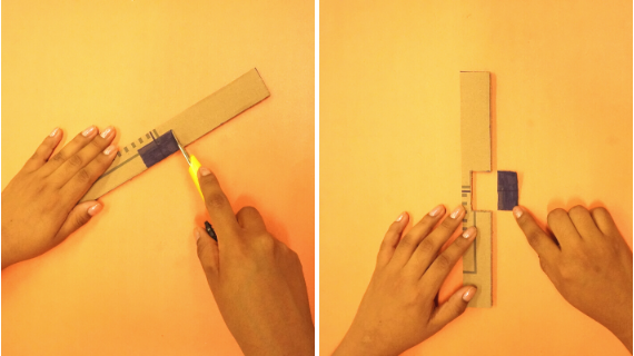 Foto com uma mão, estilete e papelão