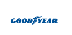 Logo da Goodyear na cor azul e entre "good" e "year" existe um desenho preenchido que remete a um calçado virado pra esquerda e uma asa.