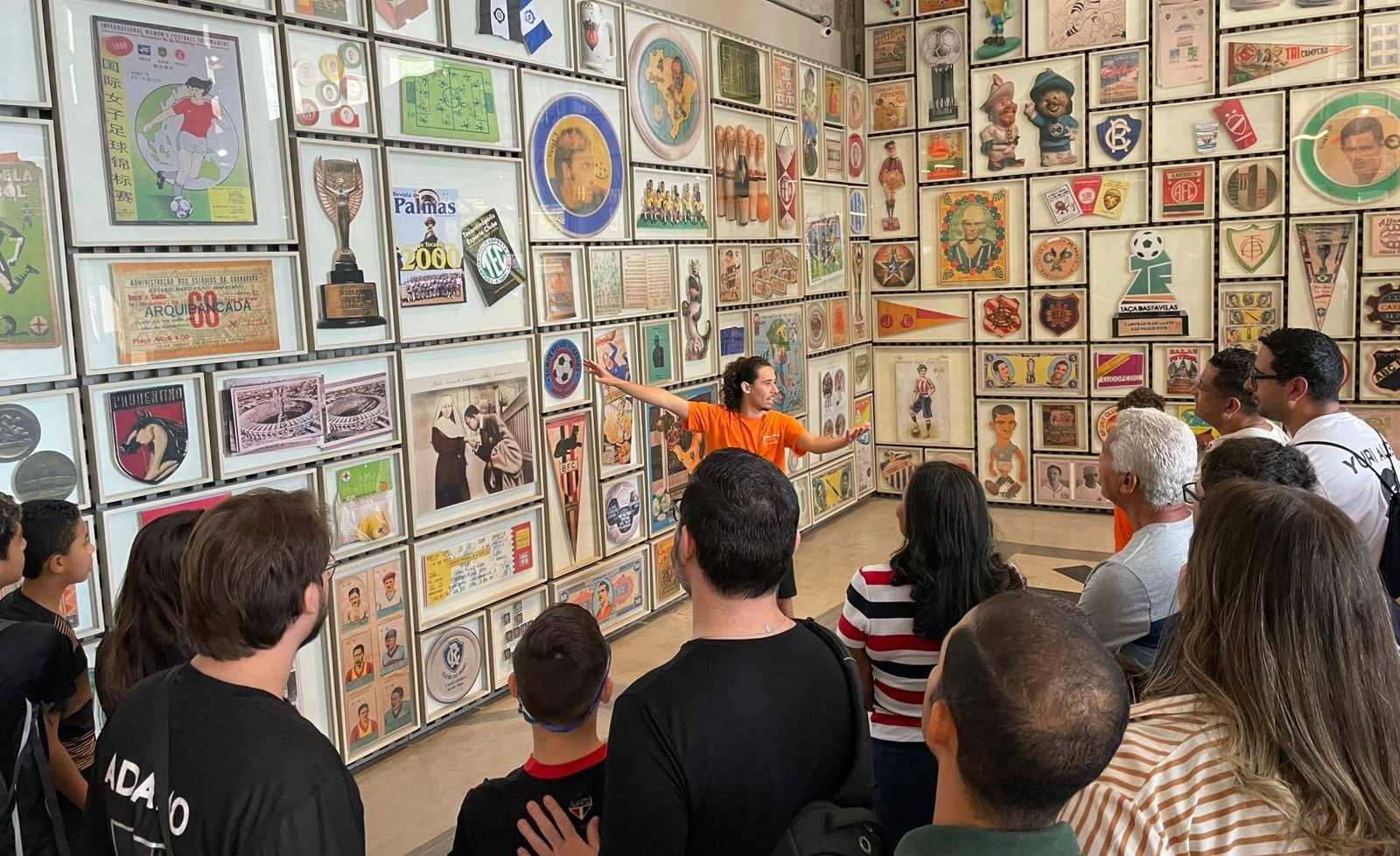Imagem de uma pessoa do educativo na sala Grande Área, atendendo o público
